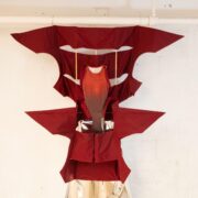 A red dress from a white pipe Description automatically generated