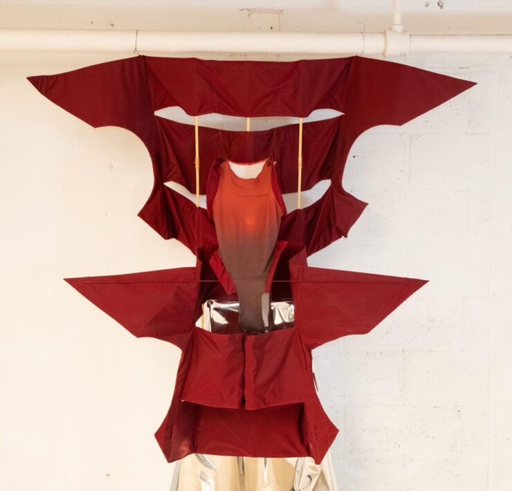 A red dress from a white pipe Description automatically generated