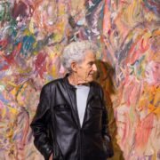 A person standing in front of a colorful wall AI-generated content may be incorrect.