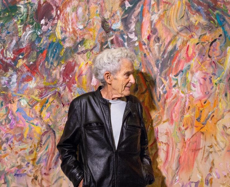 A person standing in front of a colorful wall AI-generated content may be incorrect.