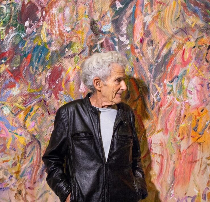 A person standing in front of a colorful wall AI-generated content may be incorrect.