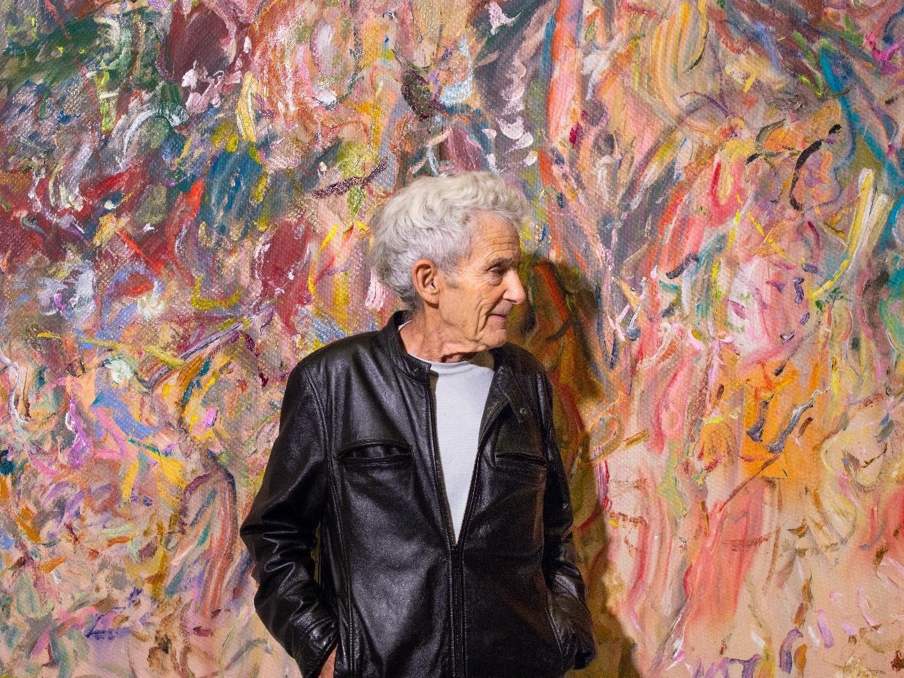 A person standing in front of a colorful wall AI-generated content may be incorrect.
