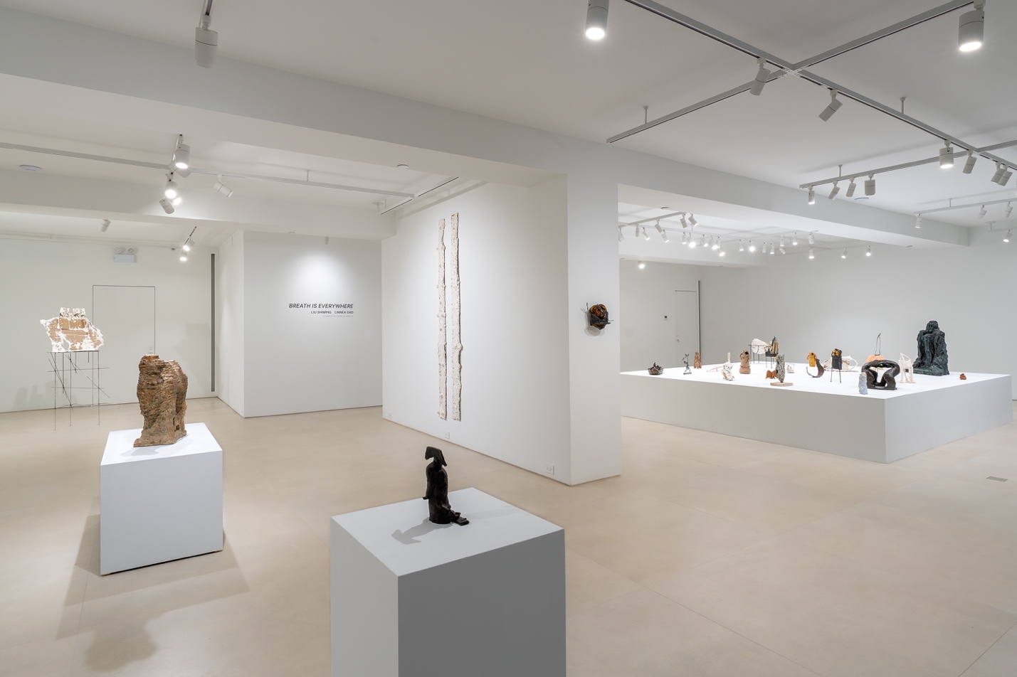 A room with white walls and white pedestalsAI-generated content may be incorrect.