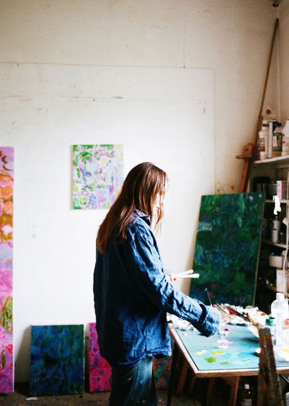 A person standing in front of a paintingAI-generated content may be incorrect.