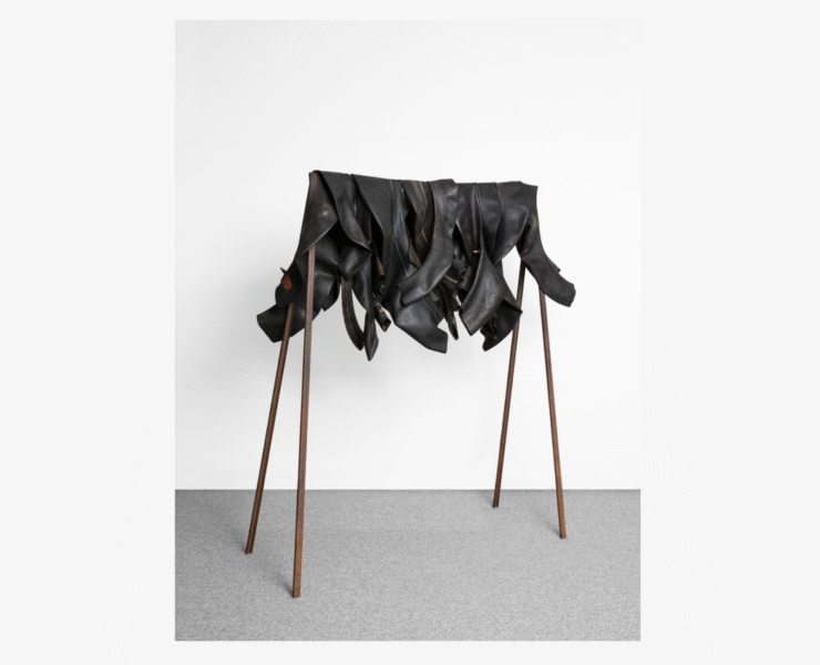 A group of boots on a rack Description automatically generated