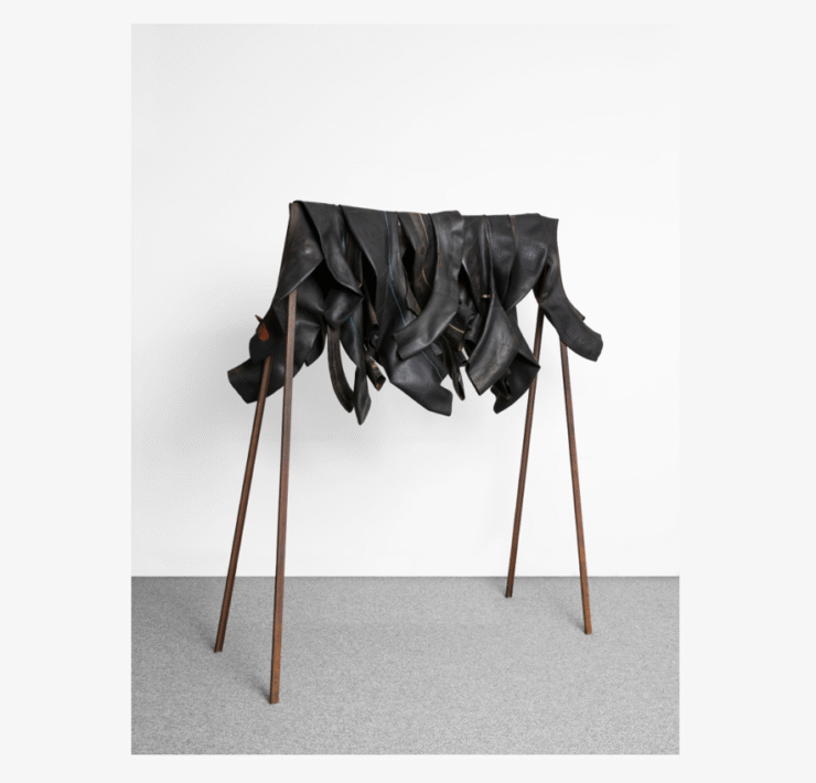 A group of boots on a rack Description automatically generated